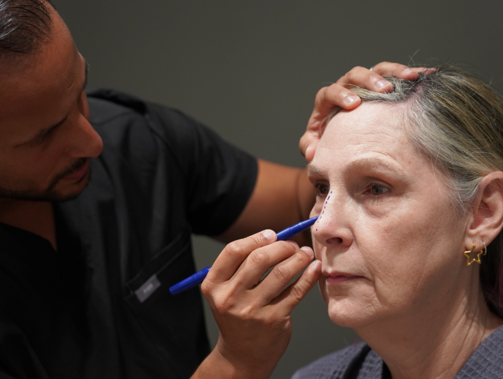 Dr. Patel marking a patient before facelift surgery at WOW Cosmetic Surgery serving Dallas-Fort Worth, TX