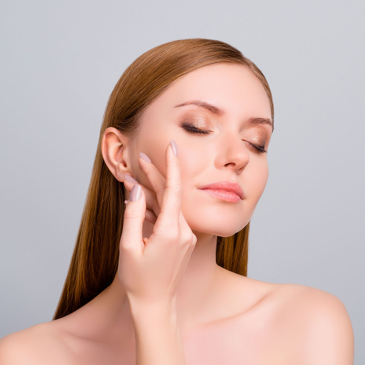 young woman touching her face