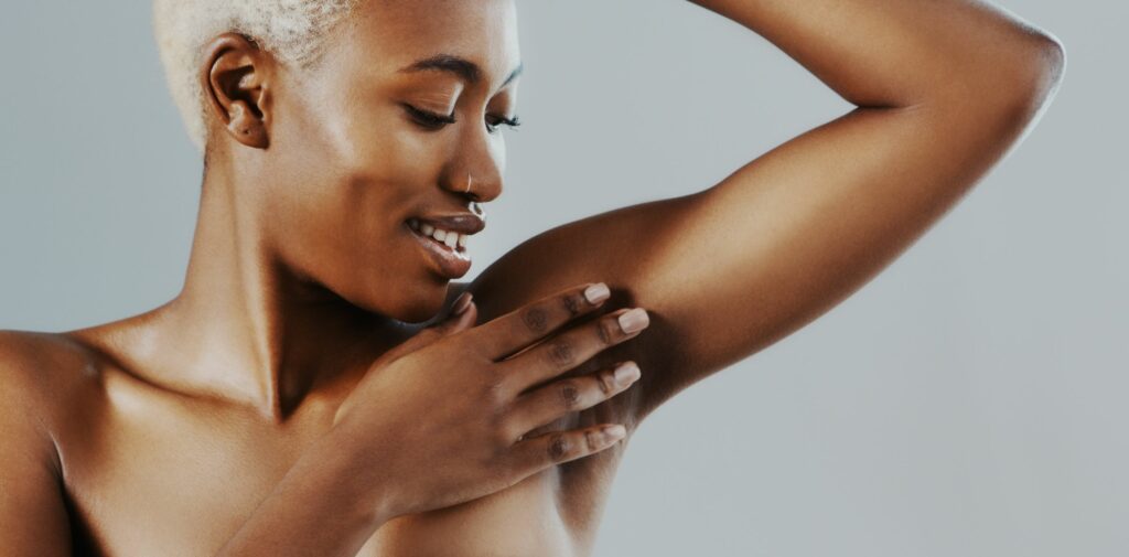 Woman with her hand over her smooth armpit