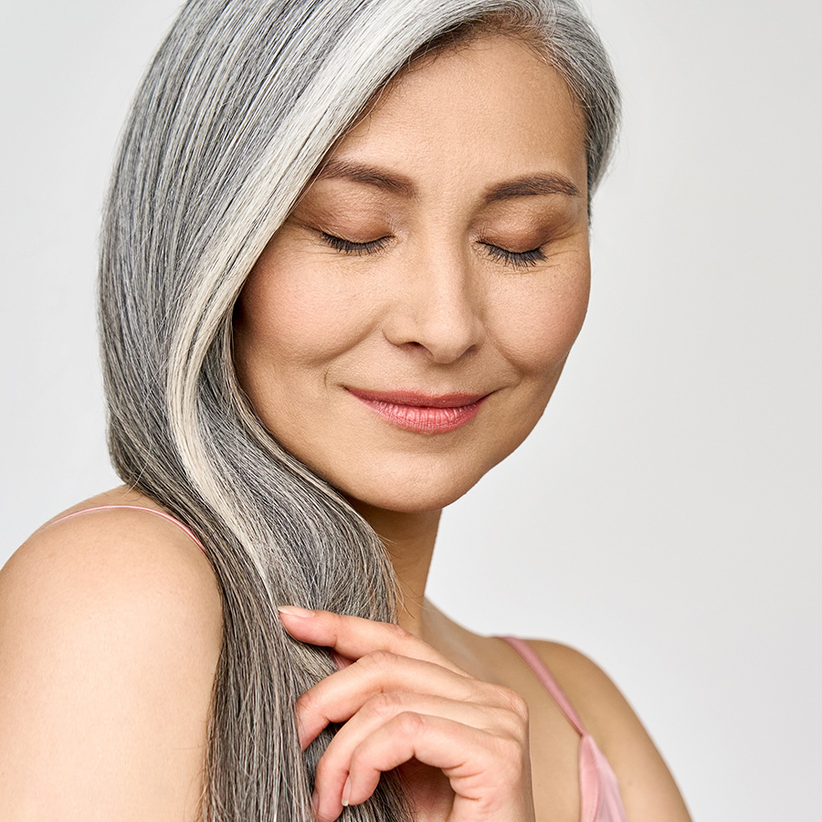 Mature woman with gray hair looking down